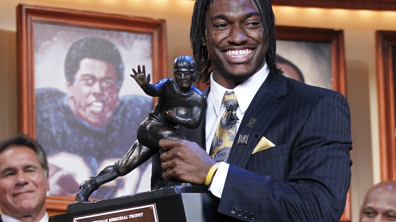 FILE - In this Dec. 10, 2011, file photo, Robert Griffin III, of Baylor University, holds the...
