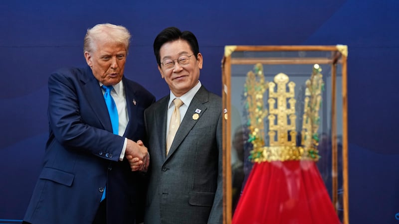 President Donald Trump shakes hands with South Korean President Lee Jae Myung as he receives a...