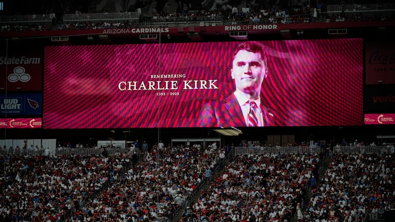 A photo of the conservative activist Charlie Kirk is seen on a large screen during a memorial...