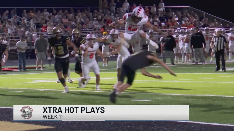 Aquilla's TC Henning leaps over a defender to score a touchdown.