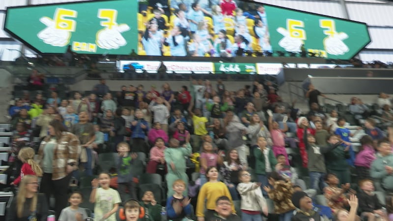 A stadium full of local elementary, middle, and high school students celebrate as the Bears...