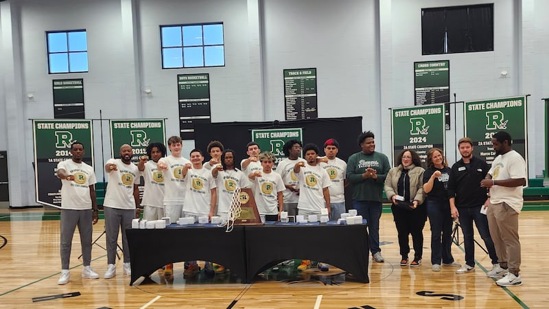 The 2024-25 Ravens with their championship hardware.